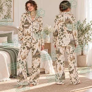 May include: A two-piece pajama set featuring a long-sleeved button-down shirt and matching pants. The fabric is cream-colored with a repeating print of castles, crowns, butterflies, swords, and ivy vines, including the text The Cruel Prince.