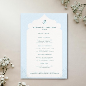 Pode incluir: Um convite de casamento azul claro com um design ornamentado e o texto "WEDDING CELEBRATIONS". O convite inclui detalhes para as cerimónias Haldi, Mehendi, Casamento e Recepção. O convite é decorado com flores brancas.