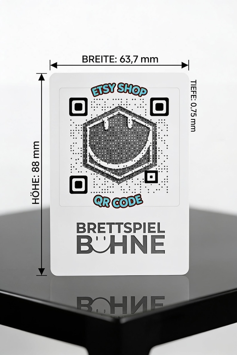 May include: A white rectangular card featuring a central QR code with a smiley face icon, the text ETSY SHOP, QR CODE, and BRETTSPIEL B&Uuml;HNE. Dimensions are marked as 63.7 mm wide, 88 mm high, and 0.75 mm deep, with arrows indicating the measured edges.