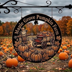 May include: A black, circular sign for Maple Grove Pumpkin Farm hangs from a decorative metal bracket. The sign features a scarecrow, pumpkins, and a wagon. The background shows a pumpkin patch and trees with autumn foliage.