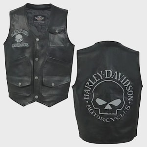 Könnte beinhalten: Schwarze Lederweste mit Harley-Davidson Totenkopf-Logos auf der Vorder- und Rückseite. Die Weste hat mehrere Taschen und eine Knopfleiste. Das Harley-Davidson-Logo ist grau.