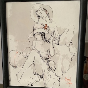 Puede incluir: Un dibujo a tinta y aguada enmarcado que muestra a dos figuras con sombreros de ala ancha. La obra utiliza líneas negras sobre un fondo beige claro con sutiles acentos rojos en los sombreros y la firma Bernard Buffet en la esquina inferior.
