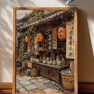 Peut inclure: Une impression d'art encadrée représentant une devanture traditionnelle avec des lanternes en papier orange, des étagères en bois présentant des bols et des pots en céramique, et des bannières suspendues avec du texte calligraphié noir.