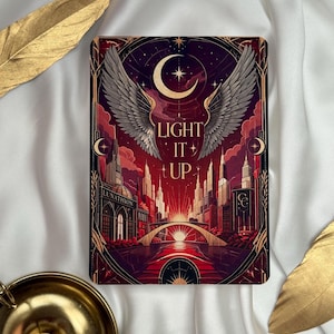 Peut inclure: Une impression d'art rectangulaire sur le thème céleste et urbain. L'œuvre présente un croissant de lune, des ailes et les mots "LIGHT IT UP". La palette de couleurs comprend des nuances de rouge, d'or et de noir, avec un paysage urbain en arrière-plan.