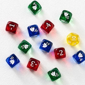 May include: A collection of colorful dice, including red, green, blue, and yellow. The dice feature white numbers and symbols, with a variety of numerical values. The dice are scattered on a white surface, suitable for tabletop games.