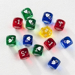 May include: A collection of colorful dice, including red, green, blue, and yellow. The dice feature white symbols and numbers, with some displaying plus and minus values. A yellow, multi-sided die is also present.