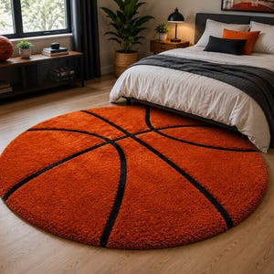 May include: A circular area rug featuring a vibrant orange textured surface with black lines designed to resemble the pattern of a basketball. The rug is positioned on a light-colored wooden floor, providing a bold focal point in the room.