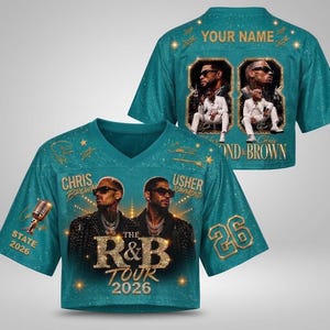 May include: A teal V-neck jersey featuring a graphic of Chris Brown and Usher, the text "THE R&B TOUR 2026", a microphone, and the number 26. The back displays "YOUR NAME" and two framed photos of the artists with the text "CHRIS BROWN & BROWN".