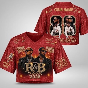 May include: A red glitter-effect V-neck jersey featuring portraits of Chris Brown and Usher, the text "THE R&B TOUR 2026", "CHRIS BROWN", "USHER RAYMOND", "STATE 2026", and the number "26". The back displays "YOUR NAME" and two framed photos of the artists.