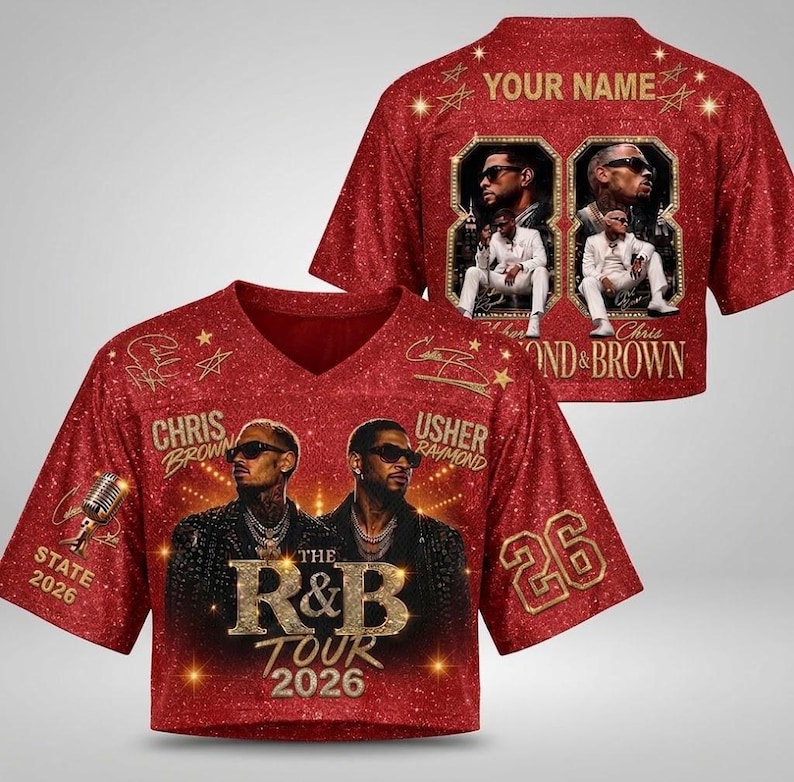 May include: A red glitter-effect V-neck jersey featuring portraits of Chris Brown and Usher, the text "THE R&B TOUR 2026", "CHRIS BROWN", "USHER RAYMOND", "STATE 2026", and the number "26". The back displays "YOUR NAME" and two framed photos of the artists.