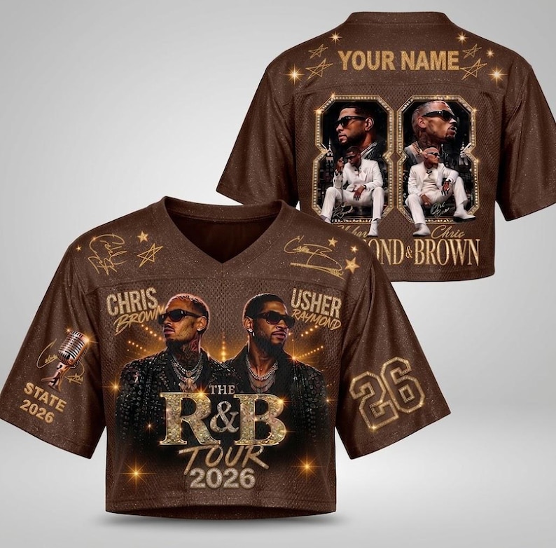 May include: A brown V-neck jersey featuring a graphic of Chris Brown and Usher, the text "The R&B Tour 2026," and the number 26. The back displays "Your Name" with two framed photos of the artists in white suits and the text "Chris & Brown."