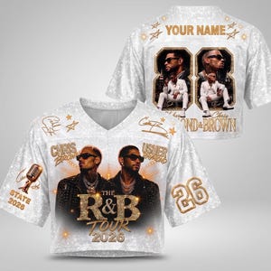 May include: A white V-neck jersey featuring a glittery texture, portraits of Chris Brown and Usher, and the text "The R&B Tour 2026". The back displays "YOUR NAME" above a framed photo of the artists, with the number 88 and "Chris & Brown" text.