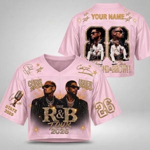 May include: A light pink V-neck jersey featuring a graphic of Chris Brown and Usher with the text The R&B Tour 2026. The back displays the text Your Name, the number 88, and images of the artists. The design includes gold stars, a microphone, and the number 26.