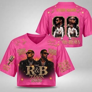 May include: A bright pink V-neck jersey featuring a graphic of Chris Brown and Usher, the text "THE R&B TOUR 2026", a microphone, and the number 26. The back displays "YOUR NAME" above two framed photos of the artists and the text "CHRIS & BROWN".