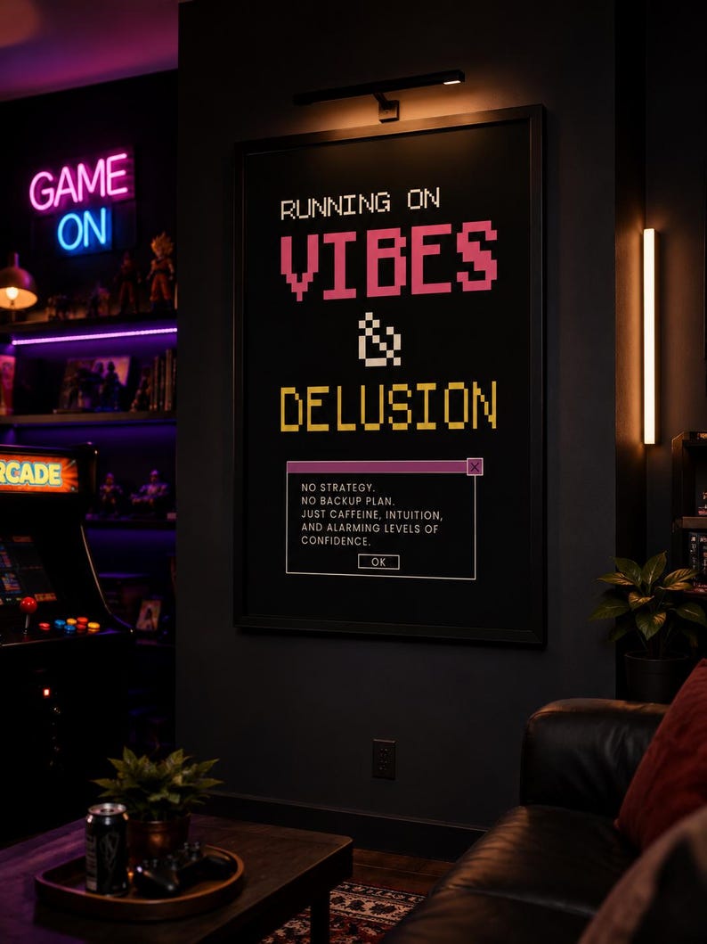 Retro gaming wall art printable in a black frame displayed in a stylish game room with arcade machine, neon lighting, gaming collectibles, leather sofa, and modern entertainment decor.