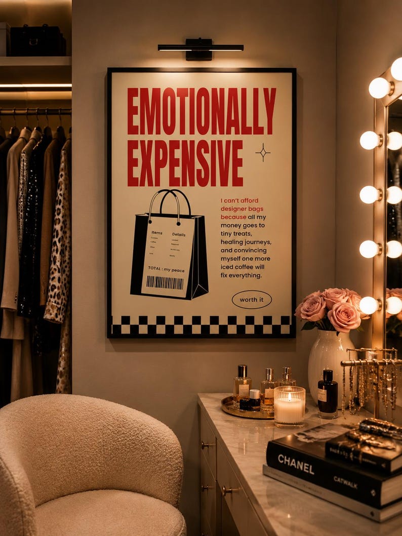 Funny fashion wall art printable in a black frame above a marble vanity in a cozy dressing room with designer perfume, candles, roses, jewelry, and clothing rack. Modern feminine aesthetic home decor.