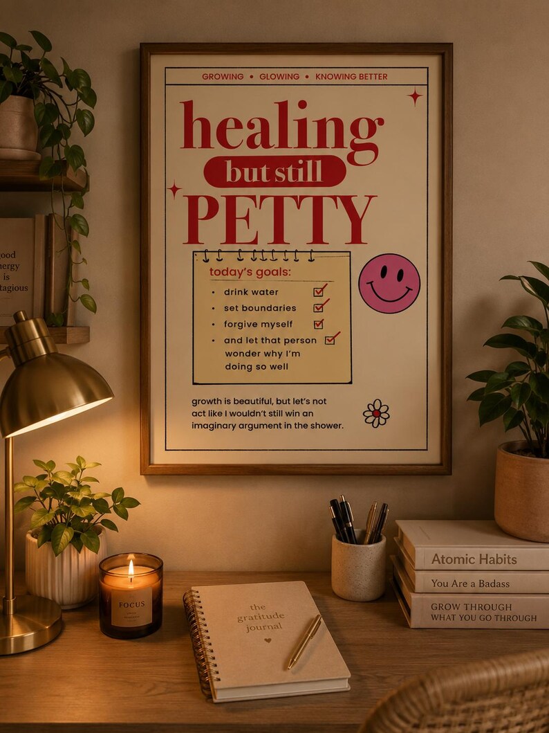 Healing typography printable wall art in a wooden frame above a cozy desk with gratitude journal, candle, books, plants, and warm home office decor for self care and mental wellness.