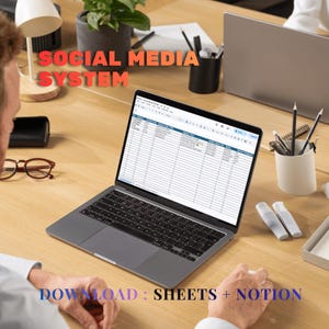 May include: A dark gray laptop displaying a spreadsheet titled Social Media System on its screen. The text Social Media System appears in orange above the laptop, and Download: Sheets + Notion is written in blue at the bottom.