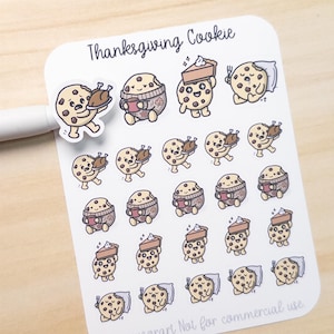 May include: A sheet of stickers with cartoon cookies celebrating Thanksgiving. The cookies are shown with turkey, coffee, pie, and pillows. The text "Thanksgiving Cookie" is at the top of the sheet.