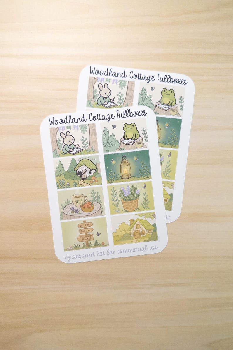 May include: Two sticker sheets with a woodland cottage theme. Each sheet features illustrated panels with a bunny, frog, cottage, lantern, and lavender. Text includes "Woodland Cottage fullboxes", "Nap Time", "Tea Time", and "Mushroom Market".