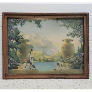 May include: A framed vintage print of a landscape with three women in a garden setting. The women are wearing flowing robes and are standing near two large urns. The background features a mountain range and a lake.