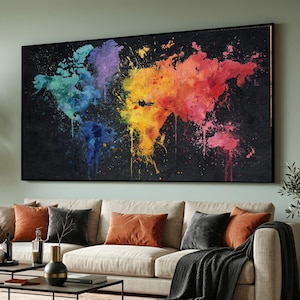 May include: A large, rectangular framed canvas art piece depicting a colorful world map. The map is rendered in a vibrant watercolor style, with continents splashed in shades of blue, green, purple, yellow, orange, and red against a black background.