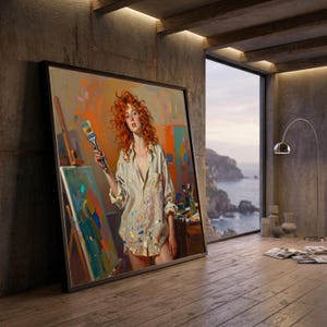 May include: A framed painting of a woman with red hair holding a paintbrush, standing in front of a canvas. The painting is leaning against a concrete wall in a room with a large window overlooking the ocean. The woman is wearing a white shirt with paint splatters.