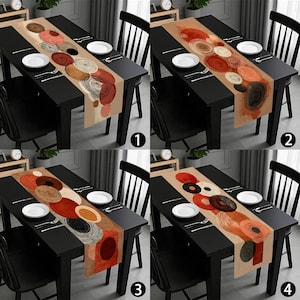 May include: A rectangular table runner with a beige background and a pattern of overlapping circles in shades of brown, red, and orange. The runner is placed on a black table set with white plates and silverware.