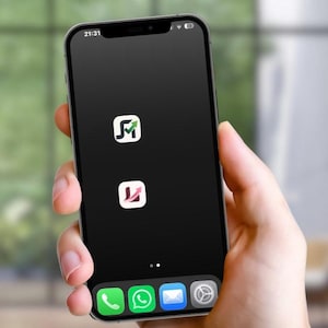 May include: A black smartphone held in a hand, showing a black screen with two app icons and a row of app icons at the bottom. The time 21:31 is displayed at the top left.