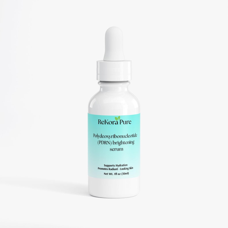 May include: A white bottle of ReKora Pure brightening serum with a dropper. The label is light blue and features the text "Polydeoxyribonucleotide (PDRN) brightening serum." It supports hydration and promotes radiant-looking skin. Net wt. 1 fl oz (30ml).