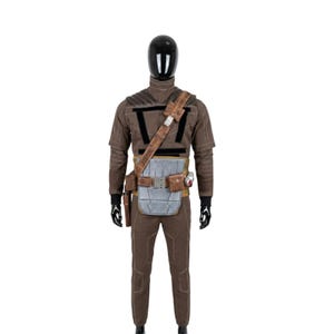 May include: A brown costume displayed on a mannequin. The outfit includes a long-sleeved shirt, pants, a utility belt with pouches, and a shoulder strap. The costume has black accents and a silver-colored chest piece.