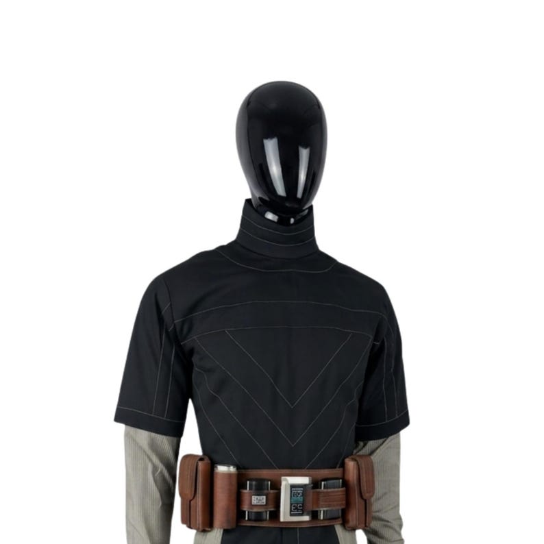 May include: Black costume with a high collar and short sleeves. The costume features a brown belt with pouches and a digital display. The outfit is displayed on a black mannequin head and a gray and white striped shirt.