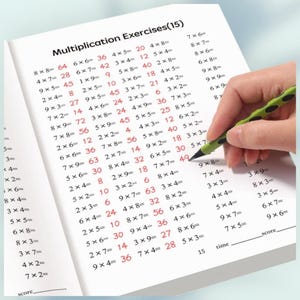 May include: A white workbook page titled Multiplication Exercises(15) featuring columns of black multiplication problems with red handwritten answers. A green and black mechanical pencil is positioned on the page near the equation 7x7=49.