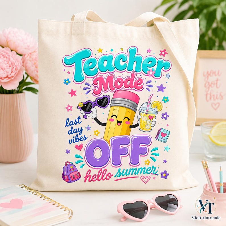 Tote bag mockup featuring the Teacher Mode Off hello summer design in a feminine pastel workspace with flowers and stationery.