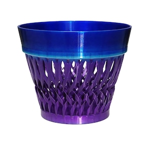 May include: A 3D-printed decorative basket in shades of blue and purple. The top rim is a deep blue, transitioning to a lighter blue, and the body features a woven, lattice-like design in purple. The base is a solid purple.