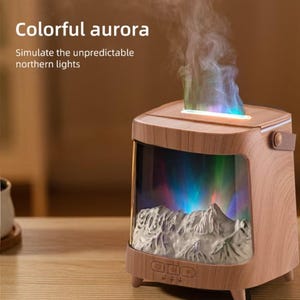 May include: A wooden-effect aromatherapy diffuser with a colourful aurora effect. The device features a mountain scene and emits a vapour stream. Text on the device reads "Colorful aurora" and "Simulate the unpredictable northern lights."