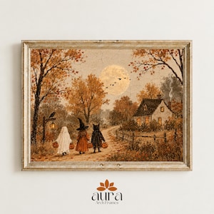 May include: A framed wall art print depicting a seasonal autumn landscape with a house, a full moon, and three figures in Halloween costumes: a ghost, a witch, and a black cat, each carrying a small orange pumpkin bucket on a dirt path.