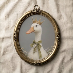May include: An oval, gold-framed portrait of a white goose wearing a gold crown and a green ribbon with flowers. The goose has an orange beak and is set against a gray background with small white flowers.