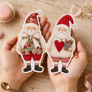 May include: Two die-cut paper figures of Santa Claus. The left figure wears a floral hat and vest with a large cream bow. The right figure wears a red polka-dot hat, a cream sweater with a red heart, and holds a small green gift box.