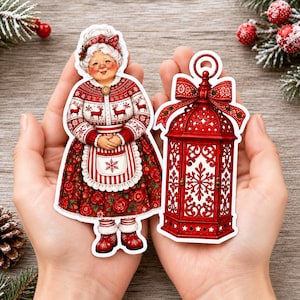 Op de afbeelding: Twee gestanste stickers met een feestelijk thema. Eén sticker toont een oudere vrouw met wit haar in een rood-witte trui, schort en rok met bloemenprint. De tweede sticker toont een rode decoratieve lantaarn met een strik aan de bovenkant.