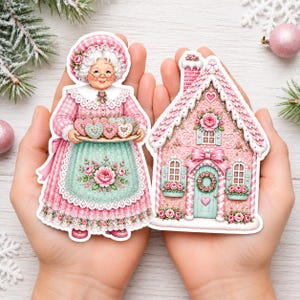 May include: Two die-cut stickers featuring a grandmother figure in a pink gingham dress with a floral apron holding a tray of heart-shaped cookies, and a pink gingerbread-style house decorated with roses, wreaths, and a heart-shaped door accent.