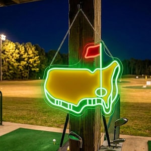 May include: A neon sign in the shape of a golf course map, with a green outline and a yellow interior. A red flag is at the top. The sign is hanging from a wooden post, with golf clubs in the foreground. The background shows a golf course at night.