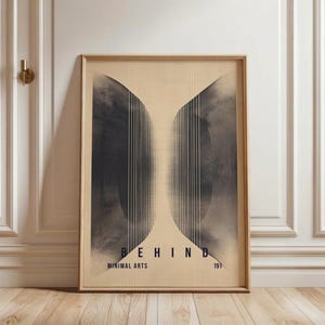 May include: A framed art print with a minimalist design. The artwork features a central graphic of two dark, abstract shapes with vertical lines, set against a light beige background. The word "BEHIND" is displayed at the bottom, along with "MINIMAL ARTS" and the number "191".