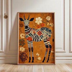 May include: A framed art print featuring a stylized gazelle with a zebra-like pattern on its head and legs. The gazelle's body is adorned with a floral pattern in shades of blue, red, and white against a warm orange background. Decorative flowers surround the gazelle.
