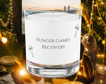 2 Variaciones de texto: Vasallaje de los Veinticinco, Vaso de Recuperación de Los Juegos del Hambre. Amanecer en la Cosecha, Vaso de Haymitch Abernathy, Merchandising de Los Juegos del Hambre, THG
