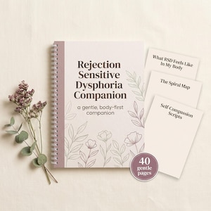 May include: A spiral-bound notebook titled Rejection Sensitive Dysphoria Companion with a gentle, body-first companion subtitle. It features floral line art, three stacked cards labeled What RSD Feels Like In My Body, The Spiral Map, and Self-Compassion Scripts, plus a round badge stating 40 gentle pages.