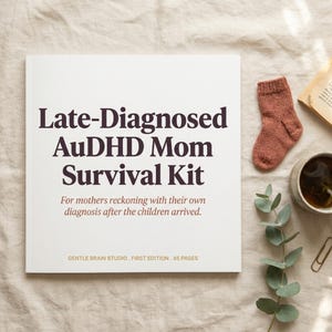 May include: A book titled "Late-Diagnosed AuDHD Mom Survival Kit" with the text "For mothers reckoning with their own diagnosis after the children arrived." A small brown sock, a cup of tea, and a sprig of greenery are also visible.