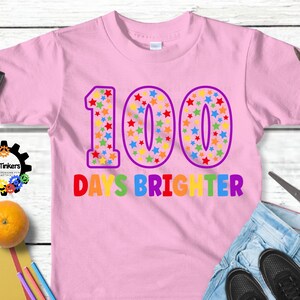 Digital design for crafting svg file for cricut silhouette clip art sublimation. 100 days of school design with a large purple outline 100 with rainbow stars speckled inside. Underneath it says days brighter in all rainbow capital letters.