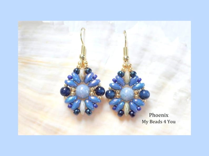 May include: A pair of dangle earrings featuring a central light blue round bead surrounded by a geometric pattern of dark blue, light blue, and metallic gold seed beads and oval-shaped beads, suspended from gold-toned metal earring hooks.