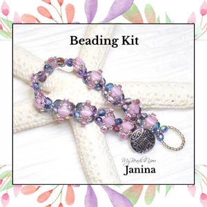 May include: A beaded bracelet featuring light pink, purple, and iridescent blue beads arranged in a repeating pattern. The bracelet includes a round silver-toned metal button clasp and a small loop. Text reads Beading Kit and Janina.